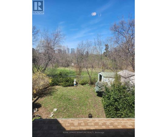 A backyard with a person standing in the middle of it.