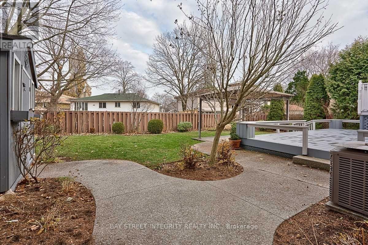 A residential area with a concrete walkway and a fence.