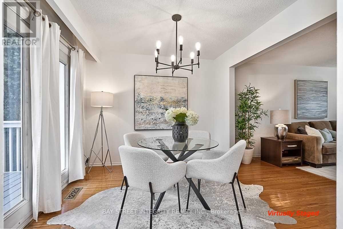 A dining room with a white table and chairs.