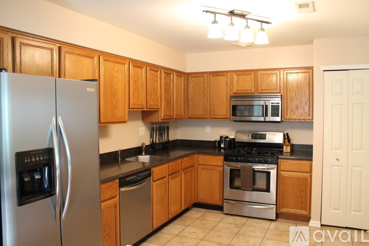 A kitchen with wooden cabinets and stainless steel appliances.