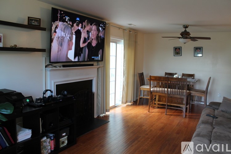 A living room with a television and a fireplace.