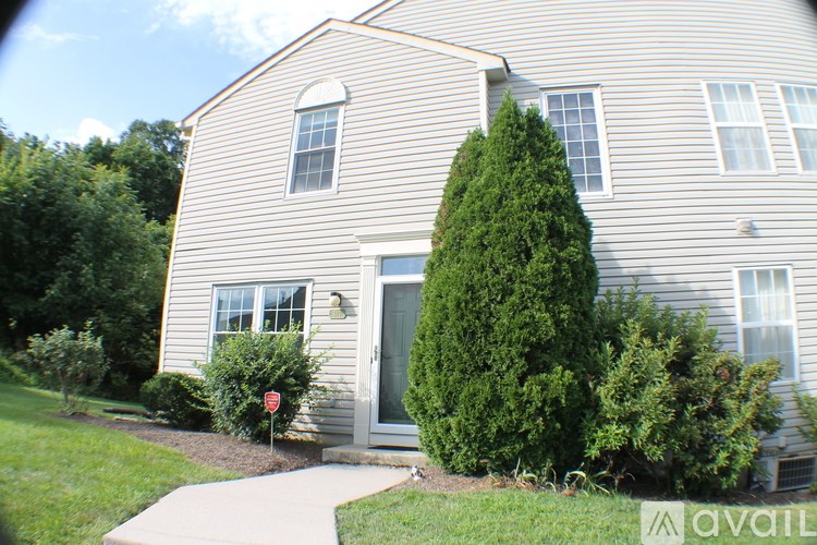 A house with a grey siding and a white door.