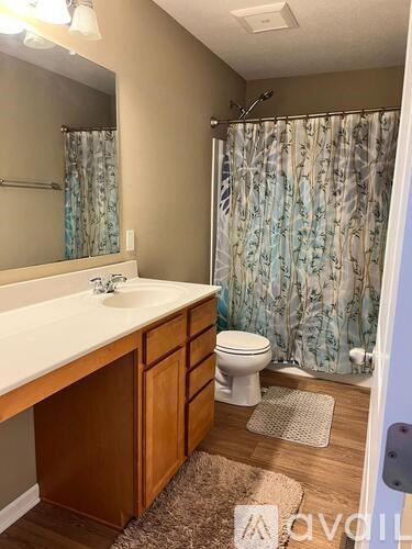 A bathroom with a white sink and a toilet.