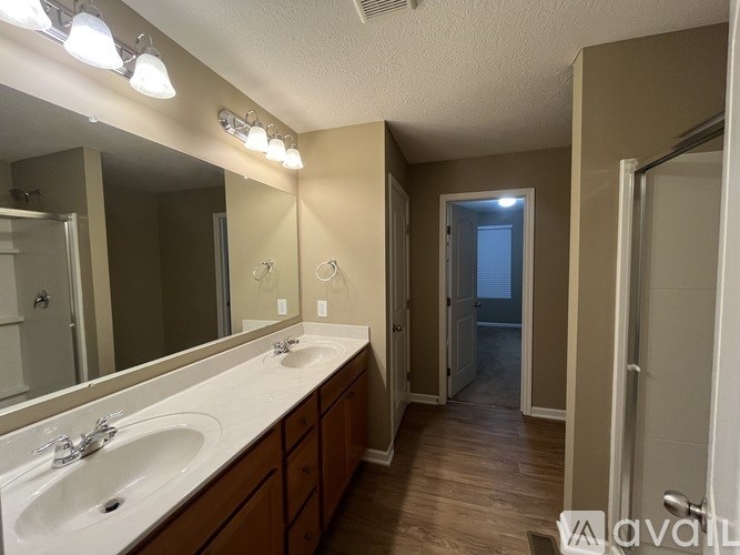A room with a carpeted floor and a window with blinds.