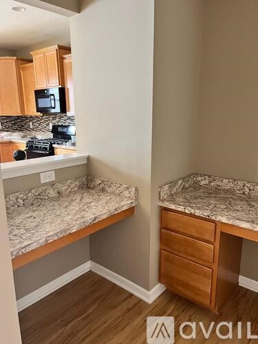 A kitchen area with a microwave, oven, and cabinets.