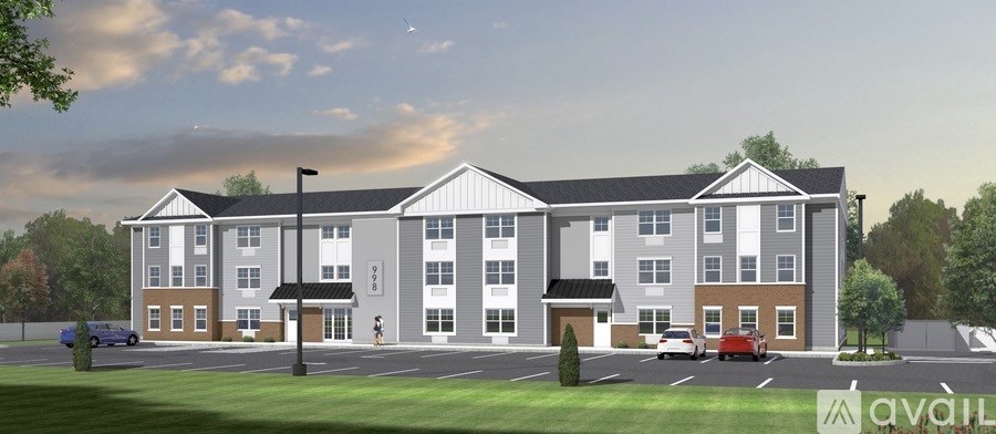 A rendering of a multi-story apartment building with a parking lot in front.