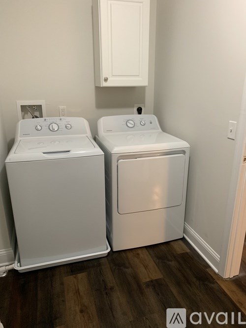 A white washer and dryer in a small laundry room.