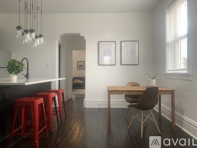 A kitchen with a bar area and a dining table.
