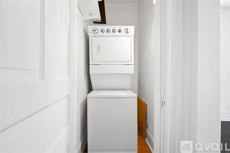 A white oven and dishwasher in a narrow kitchen.
