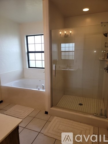 A bathroom with a tub and shower area.