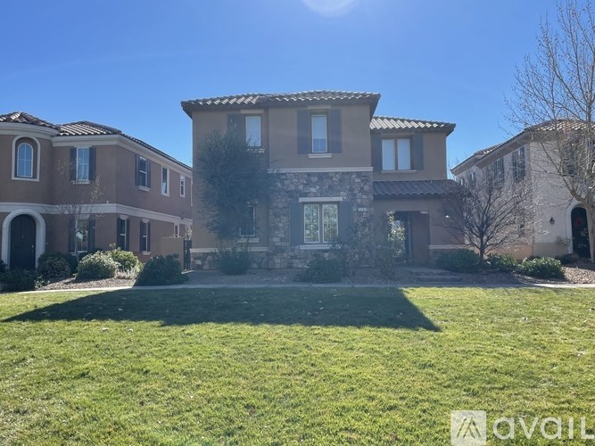 A large house with a lawn in front of it.