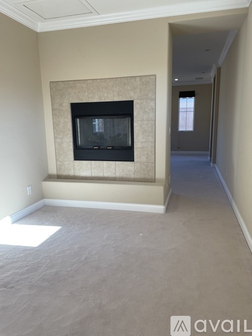 A room with a fireplace and a window.