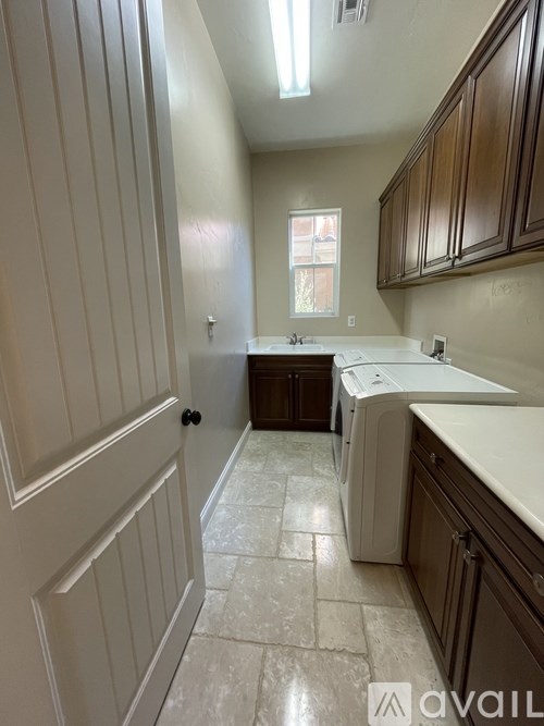 A kitchen with white cabinets and a washing machine.