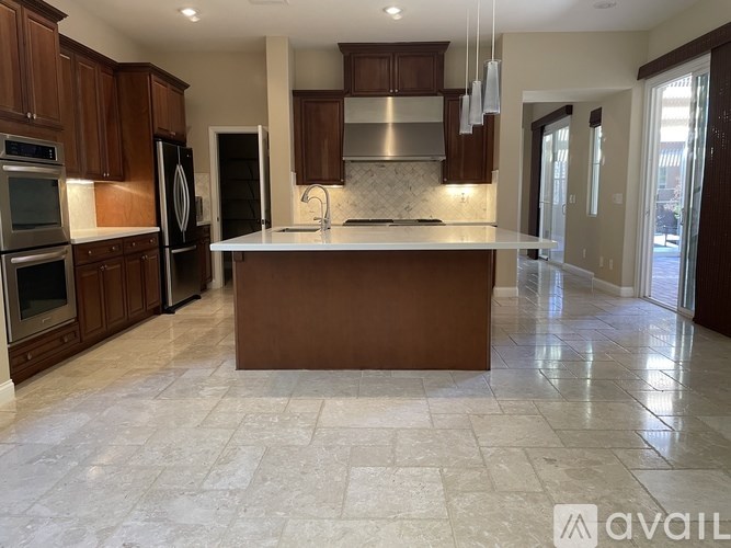 A kitchen with a large island in the middle.
