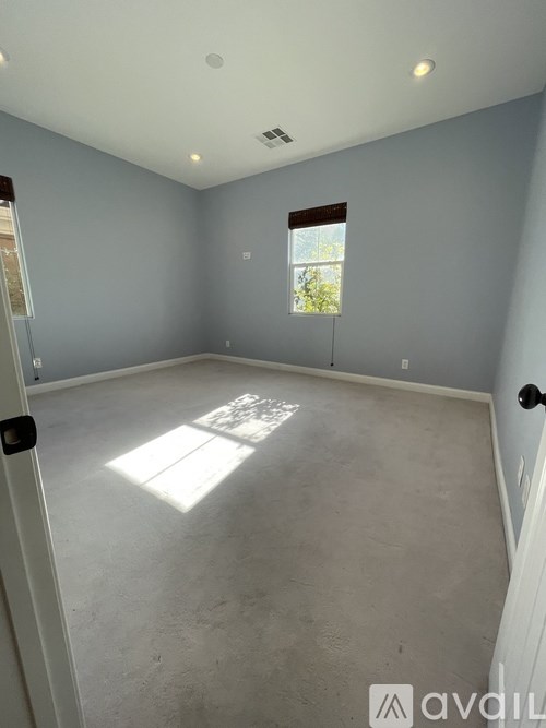 A room with a window and a door.