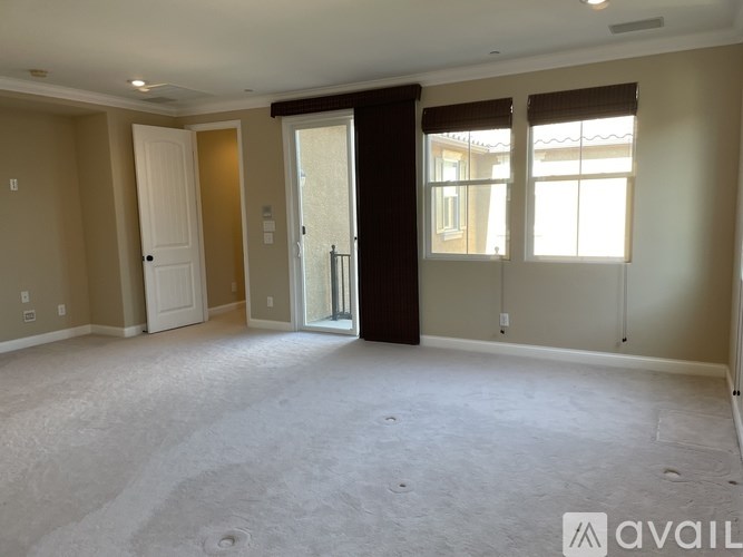 A spacious room with a door and a window.