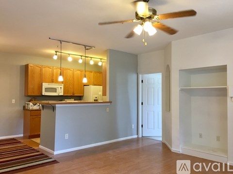 A kitchen area with a counter and a microwave.