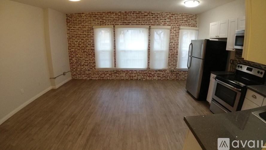 A kitchen with a refrigerator, oven, and microwave.