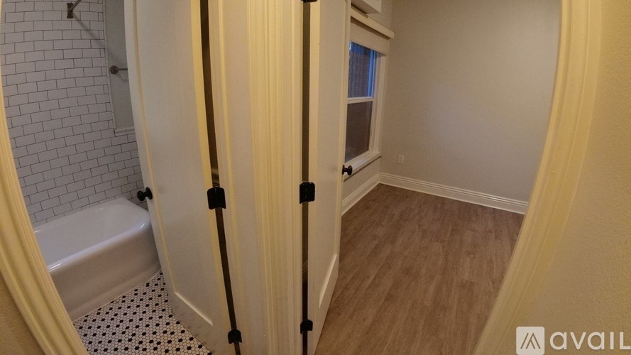 A bathroom with a tub, toilet, and sink.