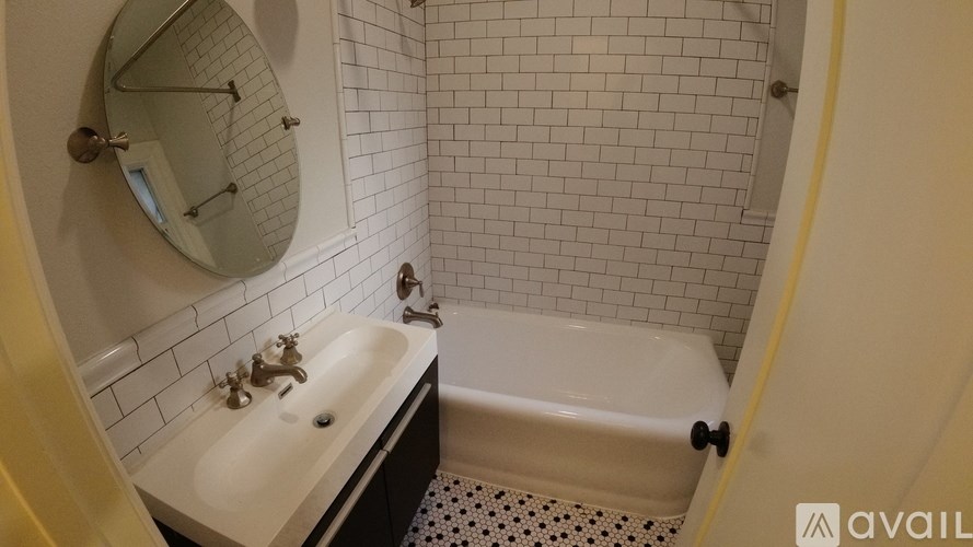 A bathroom with a white sink and a white bathtub.