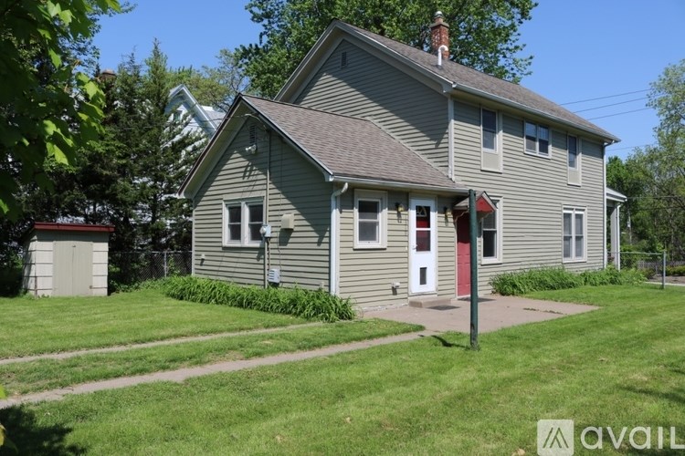 A house with a red door is for sale.
