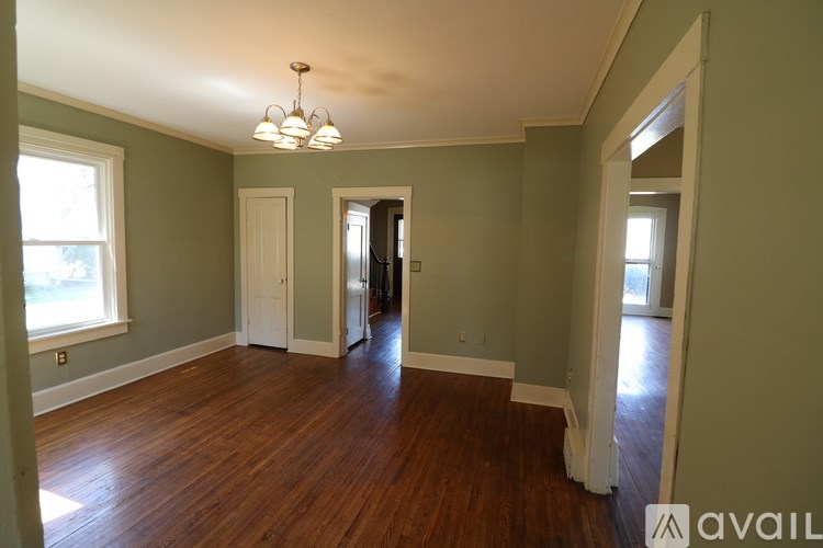 A room with wooden floors and a chandelier.