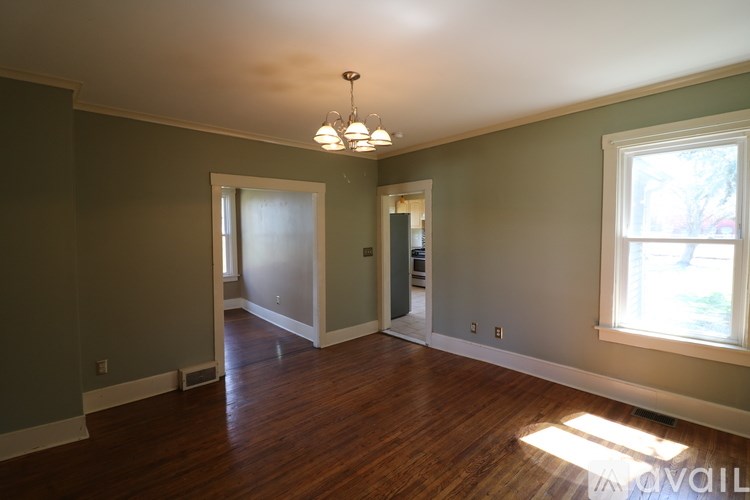 A room with wood floors and a window letting in natural light.