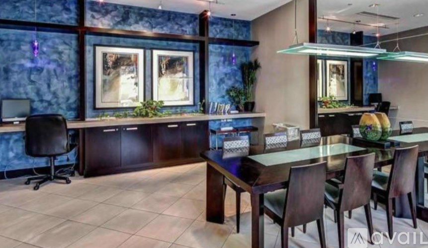 A modern office space with a glass table and chairs.