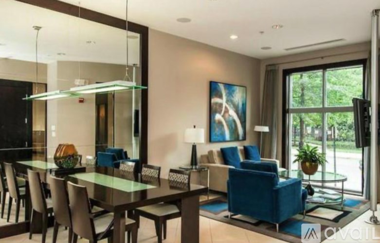 A modern dining room with a glass table and chairs.