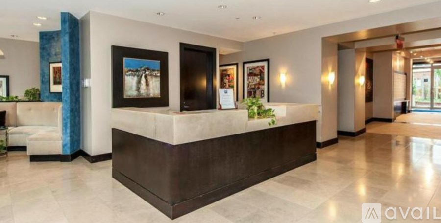 A reception area with a large desk and framed pictures on the wall.