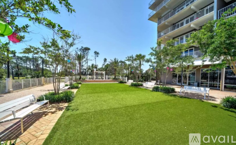 A sunny day at the park with a building in the background.
