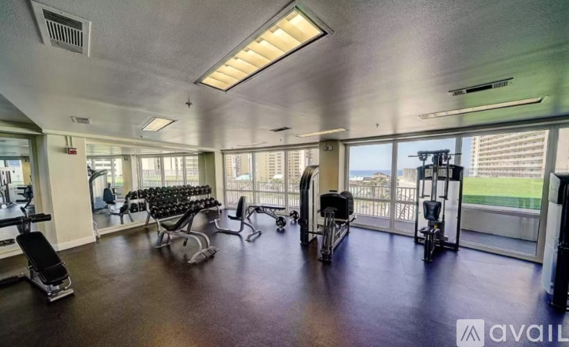 A gym with a view of the city outside the windows.