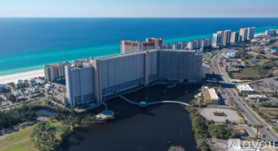 A large bridge spans a body of water with buildings in the background.