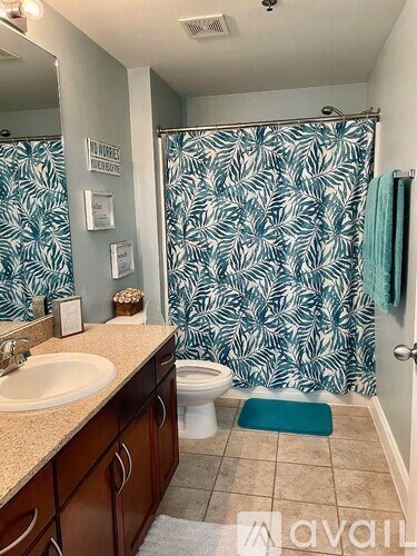 A bathroom with a sink, toilet, and shower.