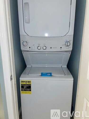 A white dishwasher with a blue sticker on the door.