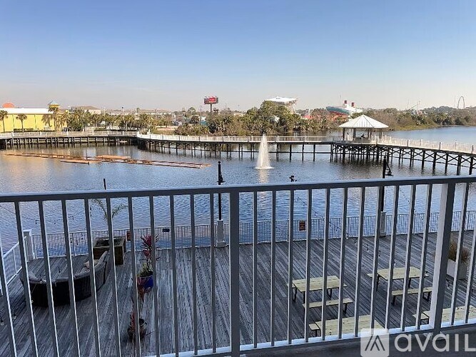 A pier with a fountain in the middle of the water.