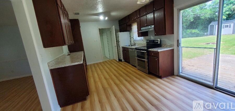 A kitchen with wooden floors and a refrigerator.