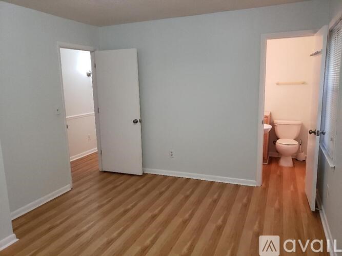 A room with a toilet and a door.