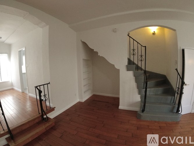 A staircase with a metal railing and wooden steps.