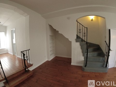 A staircase with a metal railing and wooden steps.