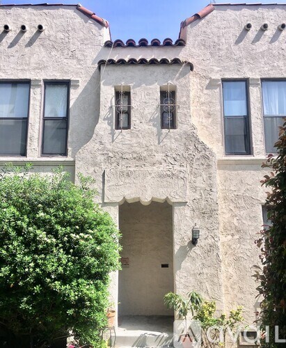 A building with a stone facade and a red tile roof.