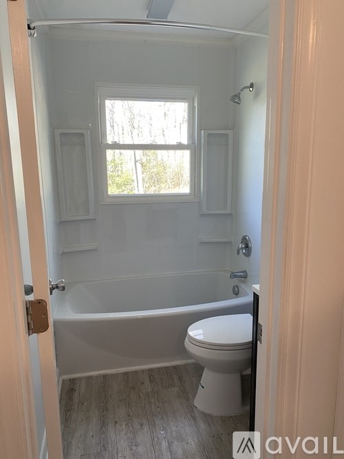 A small bathroom with a toilet and a bathtub.