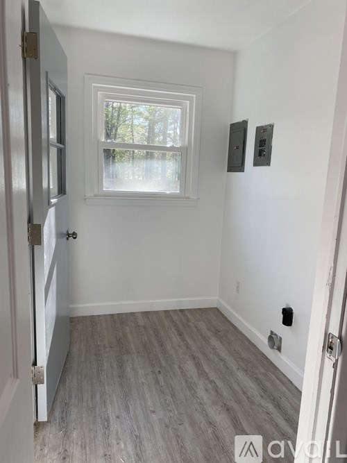 A room with a window and a door.