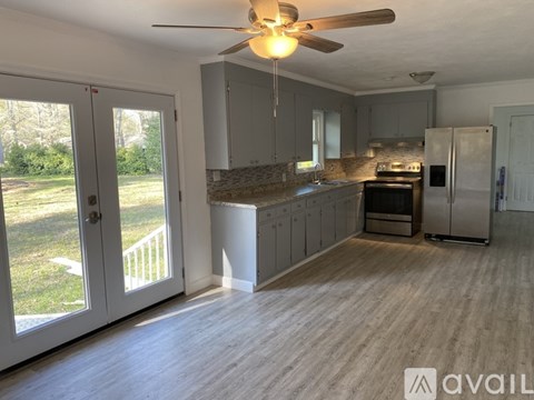 A kitchen with a refrigerator, stove, and oven.