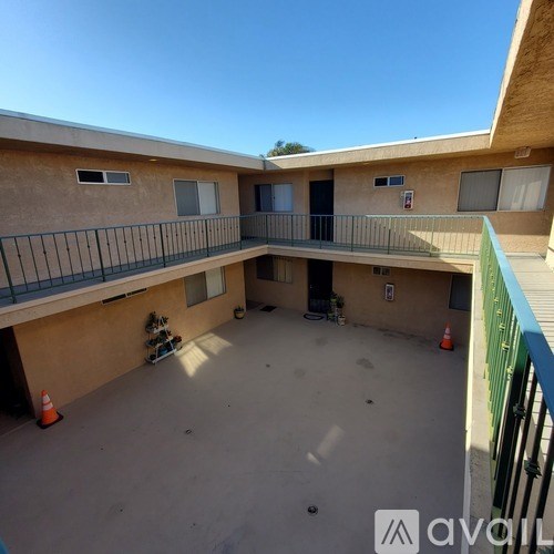 A balcony area of a building with a green railing.
