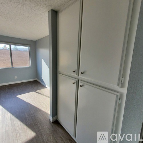 A room with a white closet and a window.
