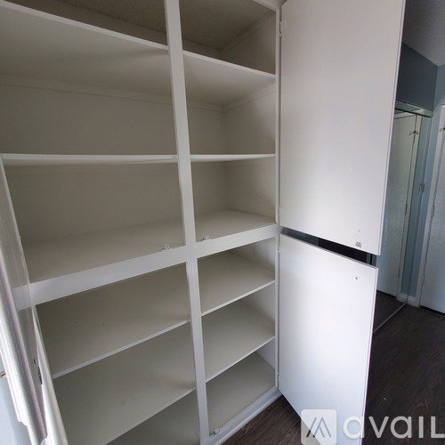 Empty white shelves in a room.