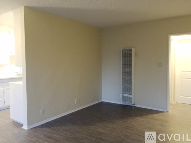 A room with a window and a door is available for rent.