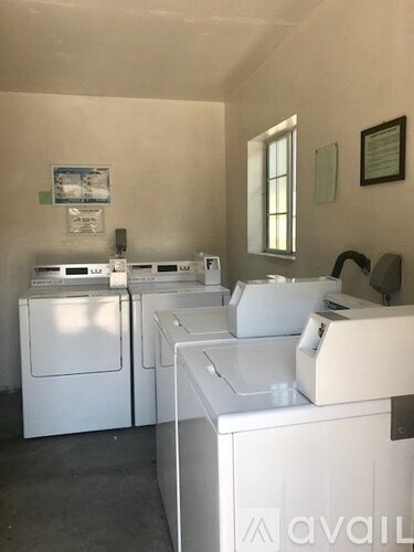 A laundry room with washers and dryers.