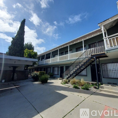 A building with a balcony and a staircase leading to it.